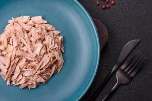 Delicious canned dietary tuna meat with salt, spices and oil photo