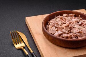 Delicious canned dietary tuna meat with salt, spices and oil photo