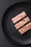 Delicious canned dietary tuna meat with salt, spices and oil photo