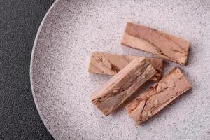 Delicious canned dietary tuna meat with salt, spices and oil photo