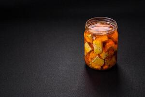 Delicious soft white feta cheese with salt, spices and herbs on a dark concrete background photo
