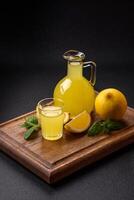 Alcoholic drink yellow limoncello in a small glass photo