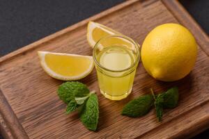 Alcoholic drink yellow limoncello in a small glass photo