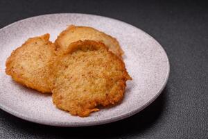 Delicious crispy pancakes made from potatoes, meat, carrots, onions photo