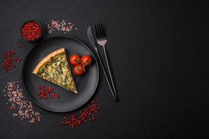 Delicious crispy quiche cut into slices with cheese, broccoli, tomatoes photo
