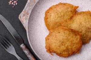 Delicious crispy pancakes made from potatoes, meat, carrots, onions photo