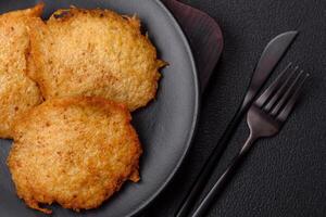 Delicious crispy pancakes made from potatoes, meat, carrots, onions photo