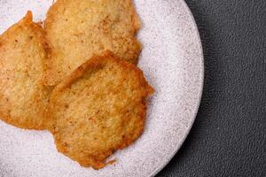 Delicious crispy pancakes made from potatoes, meat, carrots, onions photo