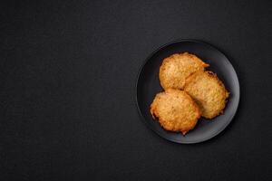 Delicious crispy pancakes made from potatoes, meat, carrots, onions photo