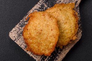 Delicious crispy pancakes made from potatoes, meat, carrots, onions photo