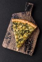 Delicious crispy quiche cut into slices with cheese, broccoli, tomatoes photo