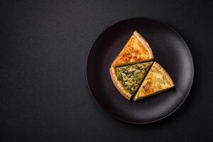 Delicious crispy quiche cut into slices with cheese, broccoli, tomatoes photo