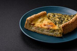 Delicious crispy quiche cut into slices with cheese, broccoli, tomatoes photo