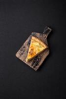 Delicious crispy quiche cut into slices with cheese, broccoli, tomatoes photo