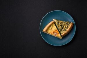 Delicious crispy quiche cut into slices with cheese, broccoli, tomatoes photo