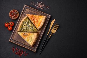 Delicious crispy quiche cut into slices with cheese, broccoli, tomatoes photo