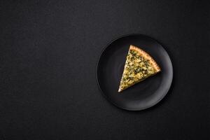 Delicious crispy quiche cut into slices with cheese, broccoli, tomatoes photo