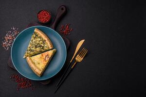 Delicious crispy quiche cut into slices with cheese, broccoli, tomatoes photo