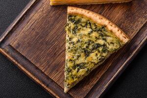 Delicious crispy quiche cut into slices with cheese, broccoli, tomatoes photo