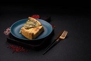 Delicious crispy quiche cut into slices with cheese, broccoli, tomatoes photo