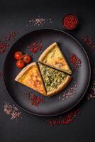 Delicious crispy quiche cut into slices with cheese, broccoli, tomatoes photo