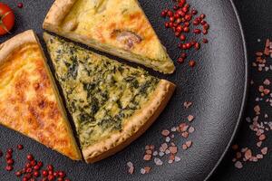 Delicious crispy quiche cut into slices with cheese, broccoli, tomatoes photo