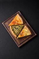 Delicious crispy quiche cut into slices with cheese, broccoli, tomatoes photo