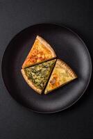 Delicious crispy quiche cut into slices with cheese, broccoli, tomatoes photo
