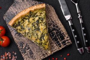 Delicious crispy quiche cut into slices with cheese, broccoli, tomatoes photo