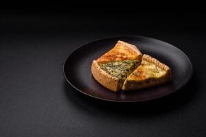 Delicious crispy quiche cut into slices with cheese, broccoli, tomatoes photo