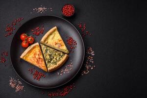 Delicious crispy quiche cut into slices with cheese, broccoli, tomatoes photo