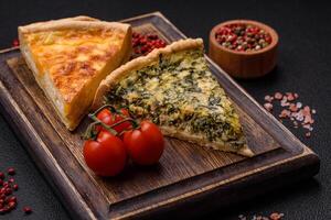 Delicious crispy quiche cut into slices with cheese, broccoli, tomatoes photo