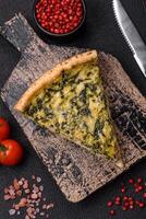 Delicious crispy quiche cut into slices with cheese, broccoli, tomatoes photo