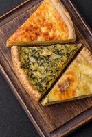 Delicious crispy quiche cut into slices with cheese, broccoli, tomatoes photo