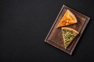 Delicious crispy quiche cut into slices with cheese, broccoli, tomatoes photo