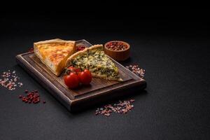 Delicious crispy quiche cut into slices with cheese, broccoli, tomatoes photo