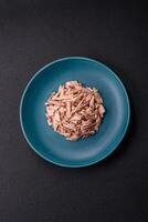 Delicious canned dietary tuna meat with salt, spices and oil photo