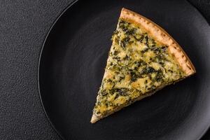 Delicious crispy quiche cut into slices with cheese, broccoli, tomatoes photo