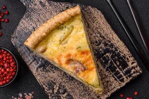 Delicious crispy quiche cut into slices with cheese, broccoli, tomatoes photo