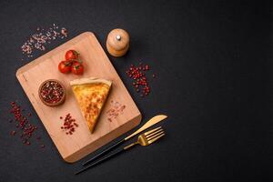 Delicious crispy quiche cut into slices with cheese, broccoli, tomatoes photo