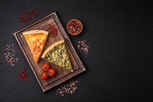 Delicious crispy quiche cut into slices with cheese, broccoli, tomatoes photo