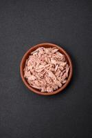 Delicious canned dietary tuna meat with salt, spices and oil photo