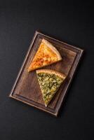 Delicious crispy quiche cut into slices with cheese, broccoli, tomatoes photo