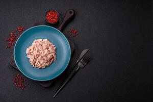 Delicious canned dietary tuna meat with salt, spices and oil photo