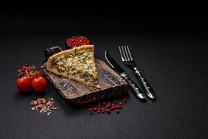 Delicious crispy quiche cut into slices with cheese, broccoli, tomatoes photo