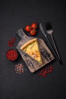 Delicious crispy quiche cut into slices with cheese, broccoli, tomatoes photo