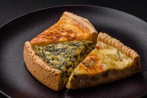 Delicious crispy quiche cut into slices with cheese, broccoli, tomatoes photo