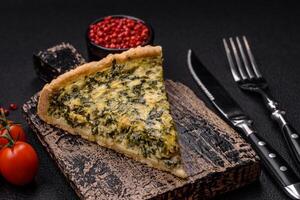 Delicious crispy quiche cut into slices with cheese, broccoli, tomatoes photo