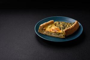 Delicious crispy quiche cut into slices with cheese, broccoli, tomatoes photo