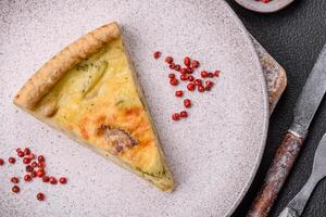 Delicious crispy quiche cut into slices with cheese, broccoli, tomatoes photo